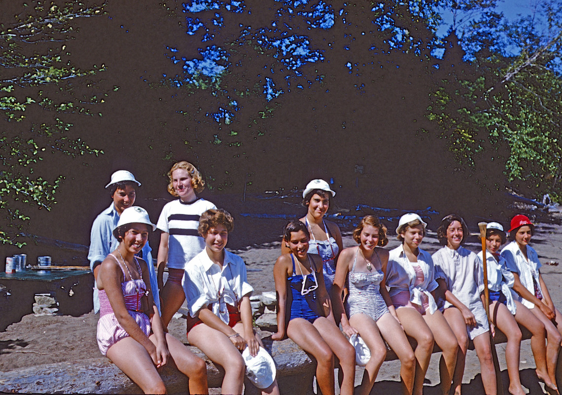 A group of campers in swimsuits and hats