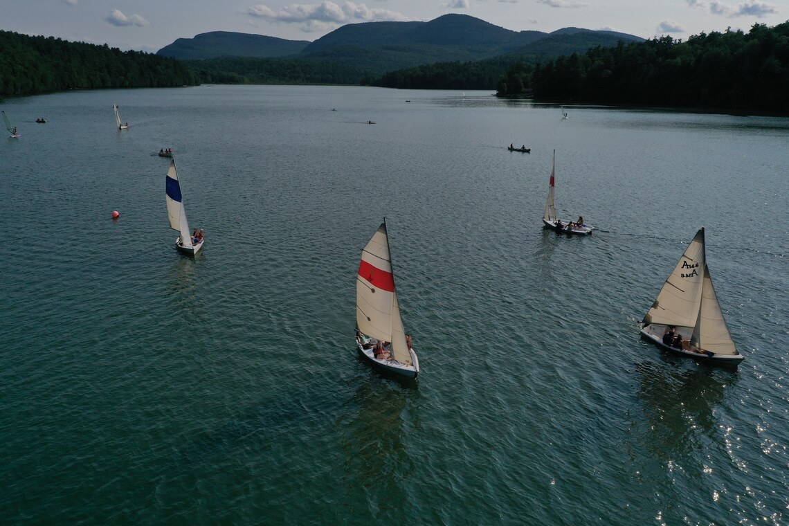 Sailboats sailing on Augur Lake under a perfectly blue sky