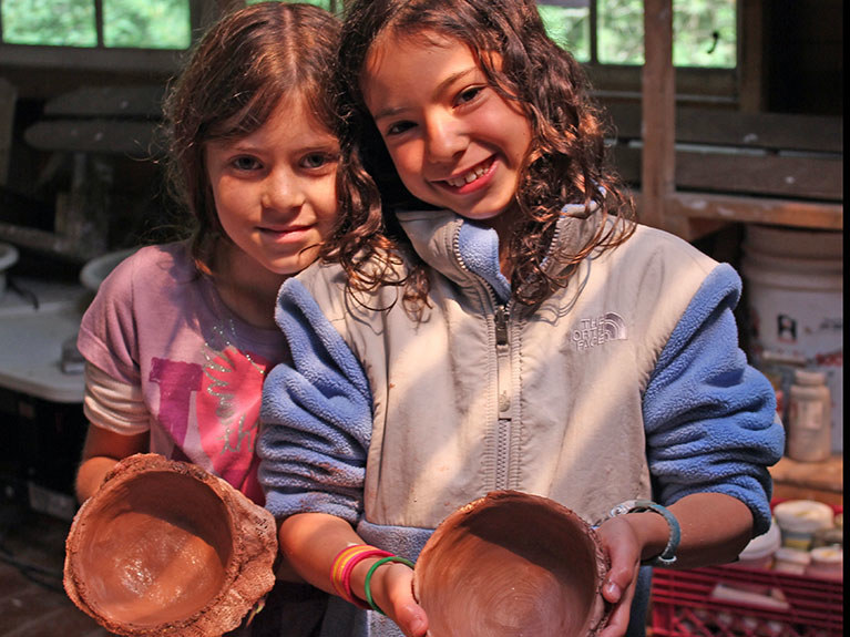 campers showing pottery they made