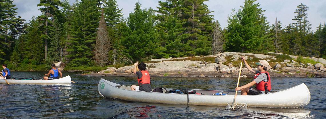 campers canoeing on lake