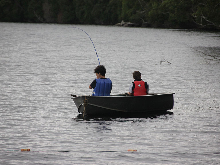 boys fishing in lake