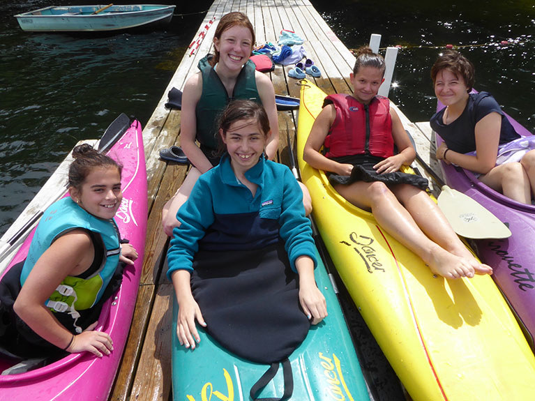 campers in dock on kayaks