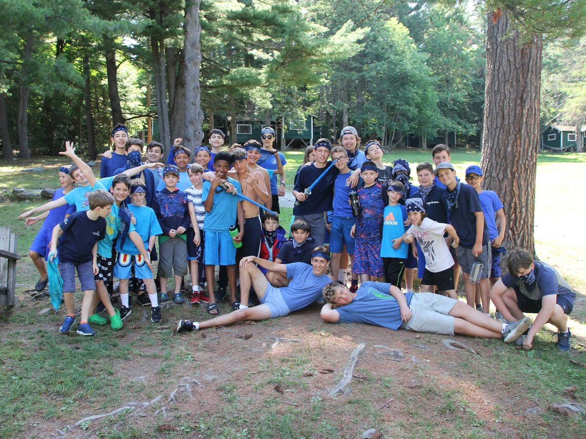 A group of campers all in blue taking part in a camp wide competition