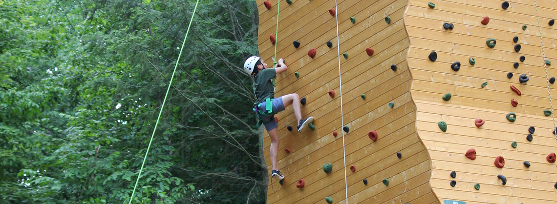 camper on climbing wall