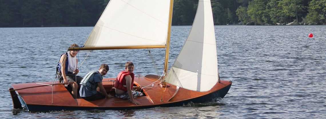 Campers sailing on lake