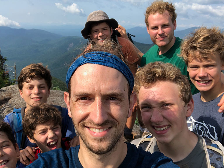 campers and counselor at top of mountain after hike
