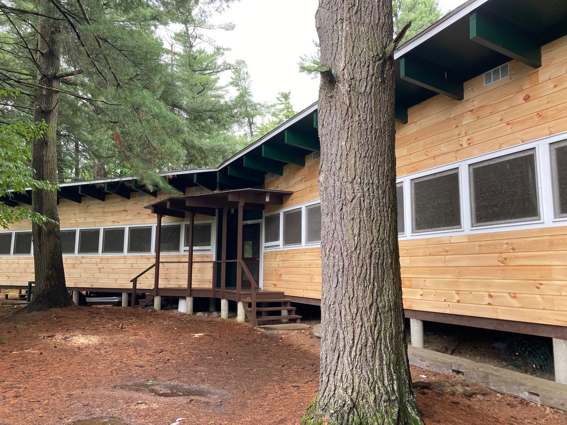 Fresh wood siding recently applied to the sides of a dining hall
