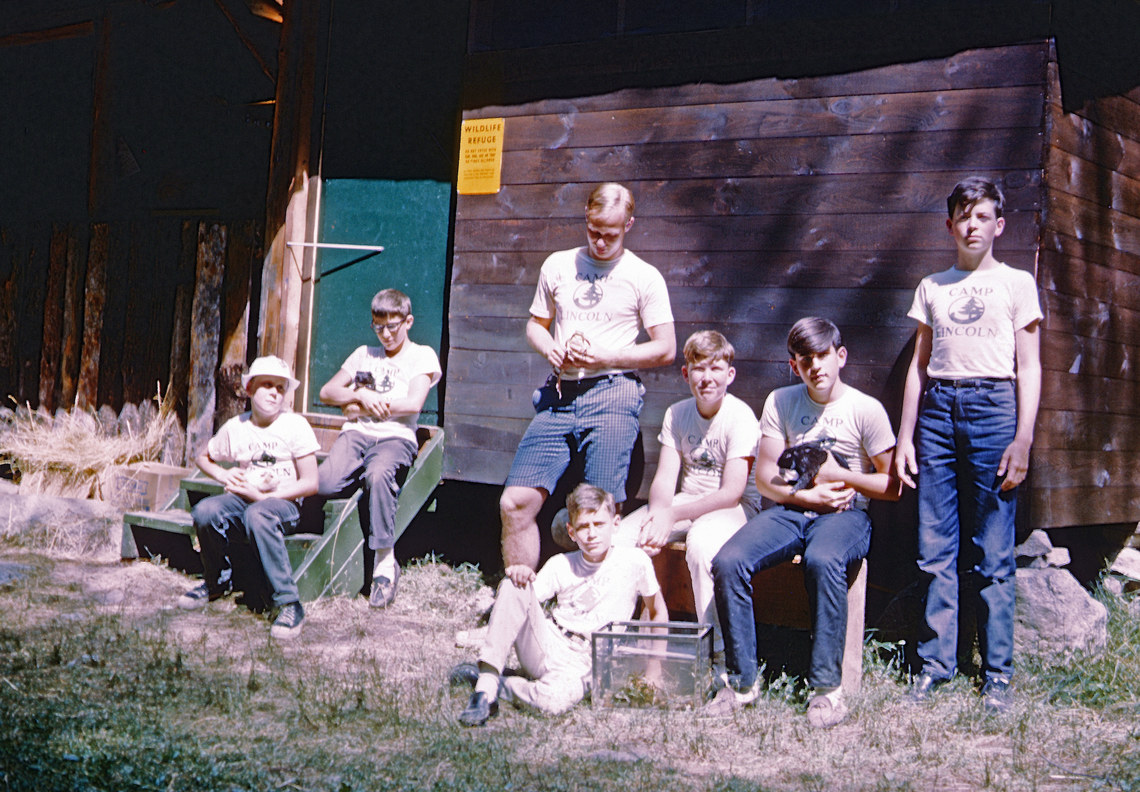 A group of campers at a wildlife refuge holding wild animals