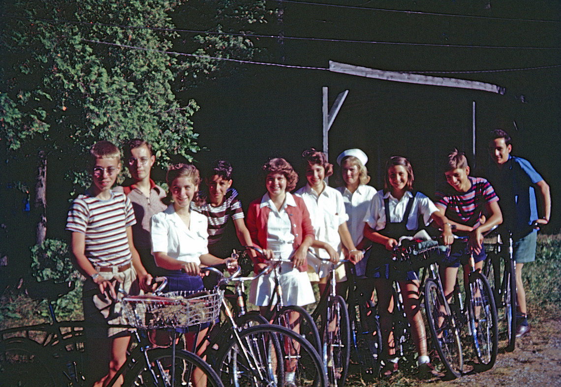A group of campers standing with bicycles